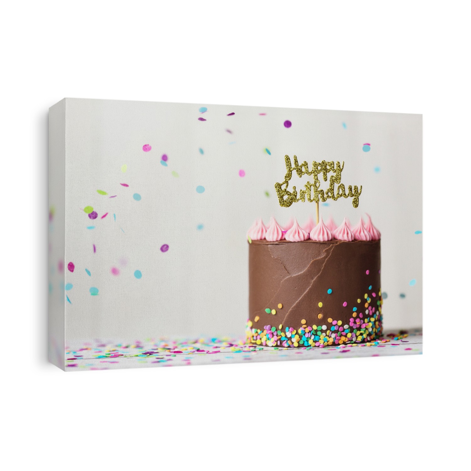 Chocolate birthday cake with happy birthday banner and falling confetti